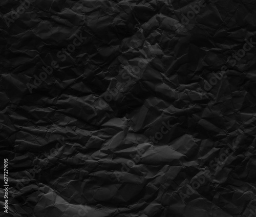Black wrinkled paper texture background.
