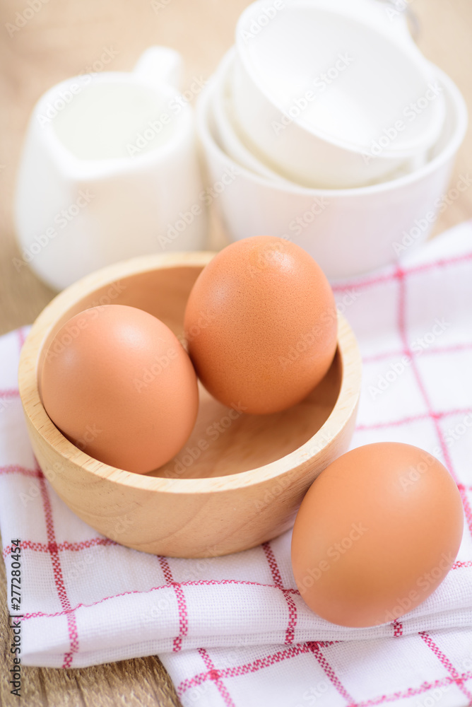 Eggs prepared for baking, placed on a wooden table Eggs prepared for baking, placed on a wooden table