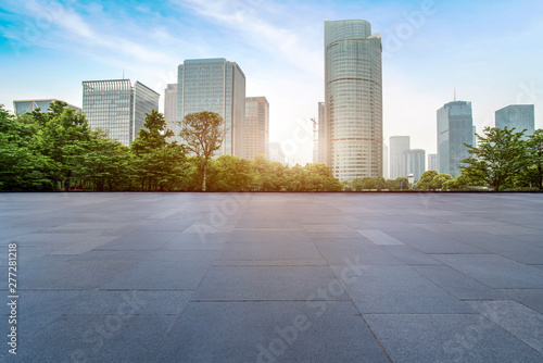 Empty square tiles and skyline of urban buildings.. © 昊 周
