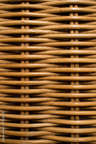 The texture of a dusty, light brown wicker chest, basket. Handmade crafted furniture, arts and crafts concepts.