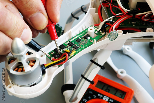 Man repairing drone. Fixing problems with quadrocopter.