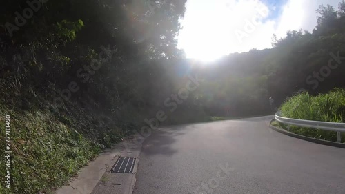 Timelapse. Walking uphill along windy road to a breathtaking view of tropical islands. Zamami Island, Okinawa, Japan photo