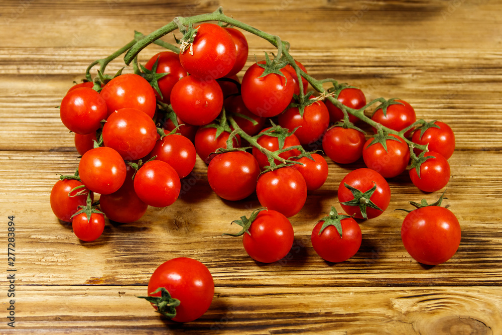 Fresh cherry tomatoes on a wooden table Fresh cherry tomatoes on a wooden table