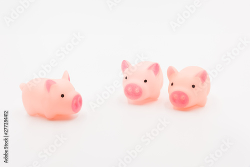 Three little pig fairy tales  three pink cute toy piglets neatly arranged on a white background