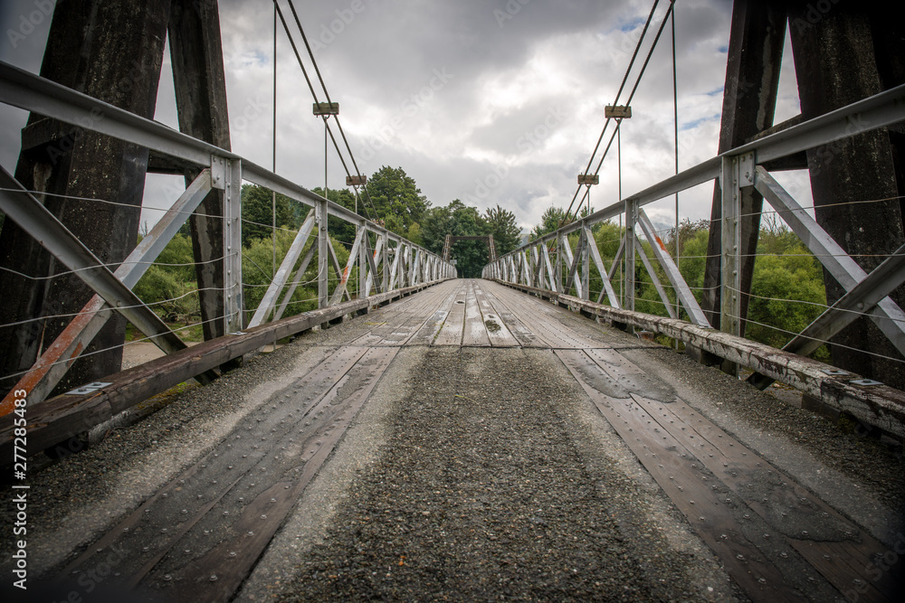 Fototapeta premium Old Road bridge crossing a new Zealand river