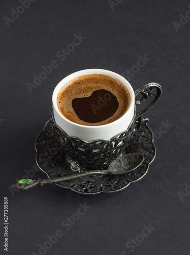 Cup of black Turkish coffee on a black background photo