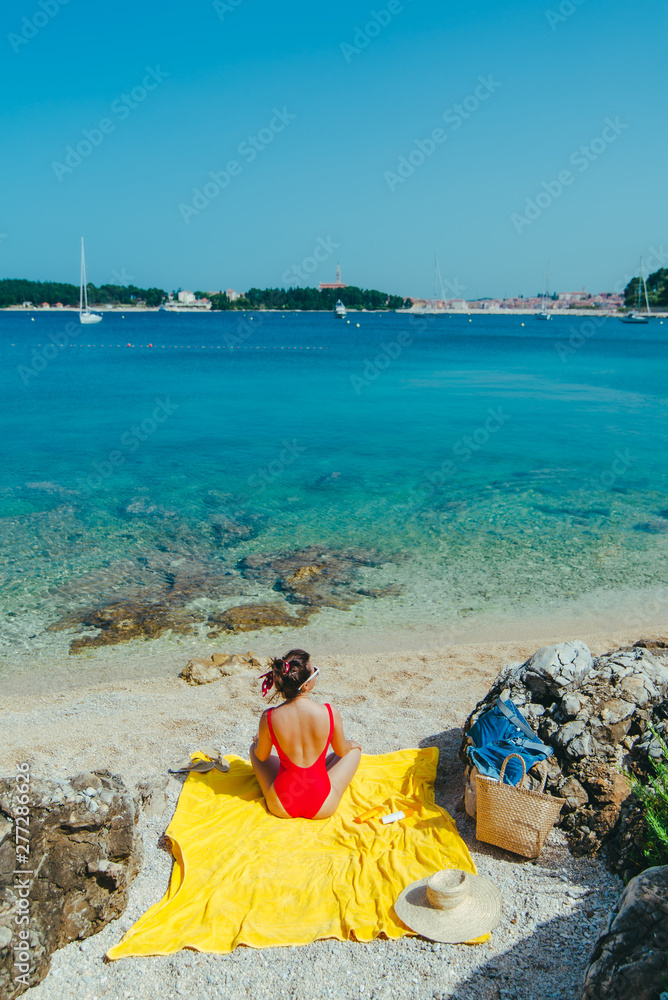woman sunbathing at sea beach in sunny day woman sunbathing at sea beach in sunny day