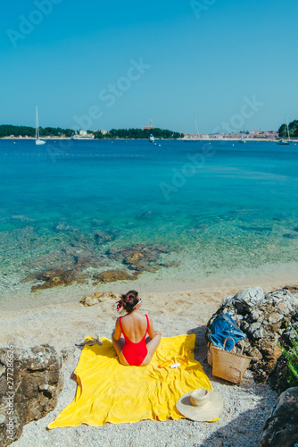 woman sunbathing at sea beach in sunny day