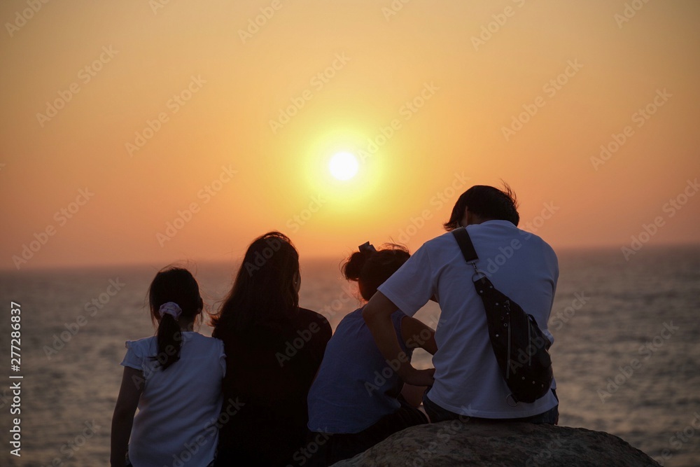 young couple watching sunset
