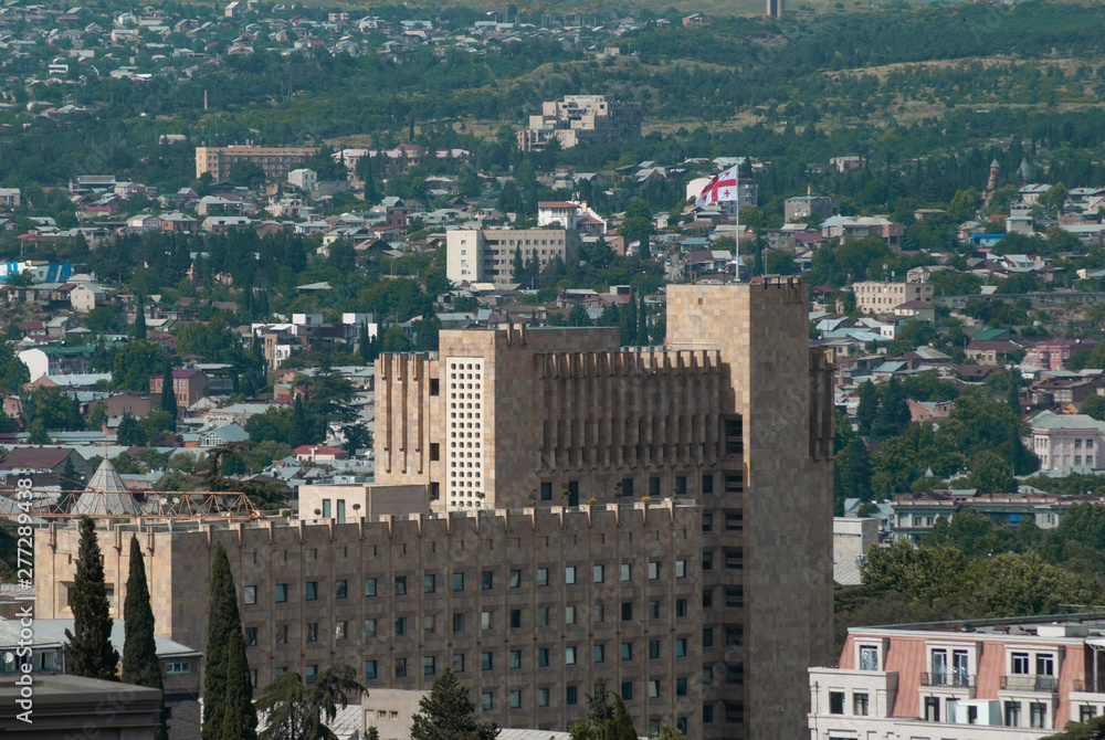 Panorama of Tbilisi in the afternoon, view of the city administration, Georgian flag,