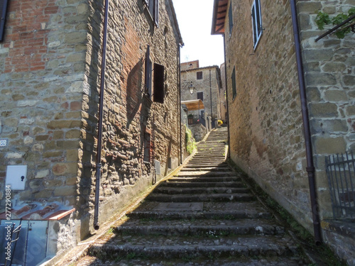 Steps of Monte del Lago between the ancient buildings. The village that overlooks the Lake Trasimeno is sorrounded by defensive medieval walls in Umbria, Italy. photo