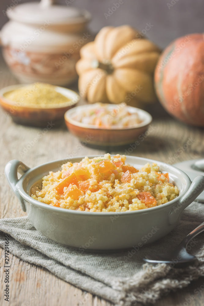 Millet porridge with sweet pumpkin in a bowl, rustic style. Healthy vegan dish. Millet porridge with sweet pumpkin in a bowl, rustic style. Healthy vegan dish.