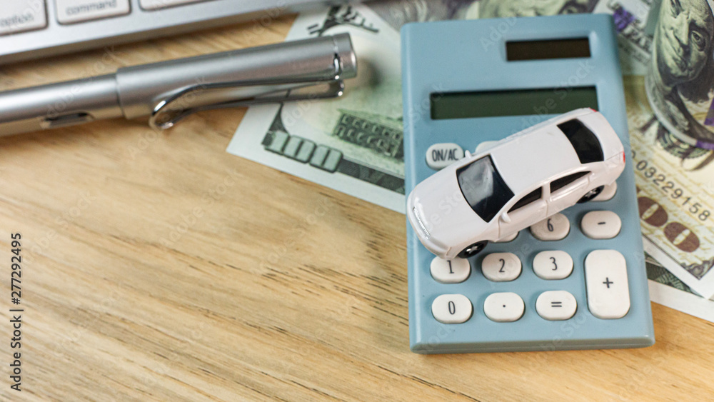 white toy car on work station table in office.. white toy car on work station table in office..
