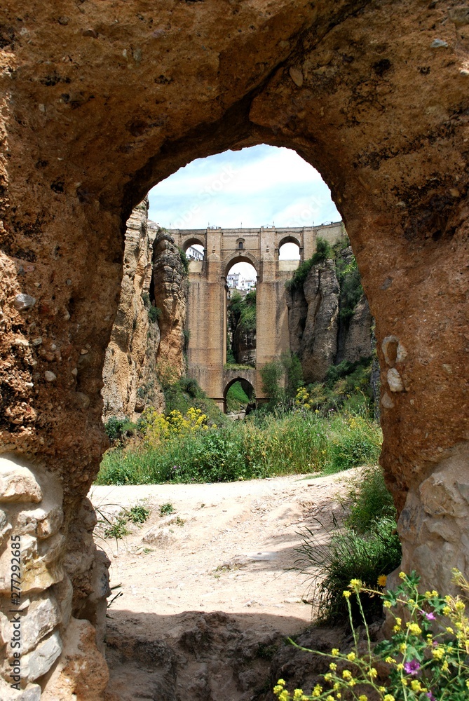 New bridge viewed from East through arabic arch, Ronda, Spain.