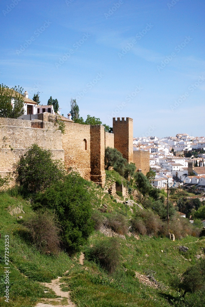 View along the old town wall towards the town, Ronda, Spain.
