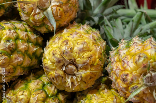 The big ripe yellow pineapples sold at farmers market photo