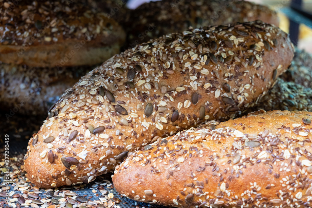 Fresh brown bread with sesame and sunflower seeds for sale at local farmers market Fresh brown bread with sesame and sunflower seeds for sale at local farmers market