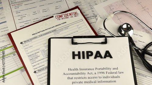 Health Insurance Portability and accountability act HIPAA, red folder with inscription confidential, medication request form and stethoscope on a blue velvet background. Close-up