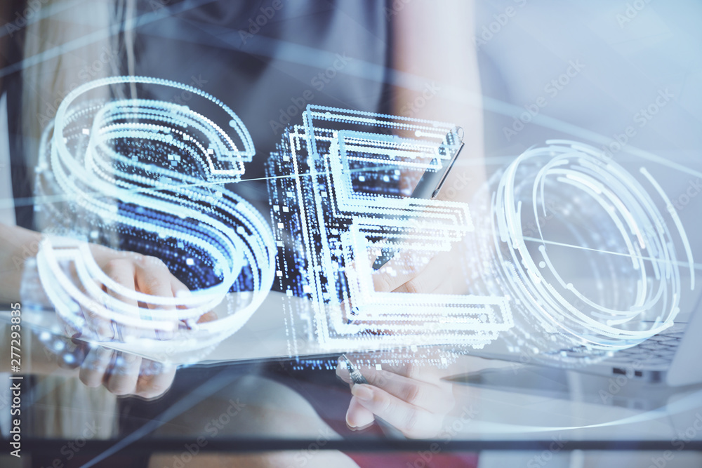 Double exposure of woman's hands making notes with SEO icon. Concept of Search engine optimization Double exposure of woman's hands making notes with SEO icon. Concept of Search engine optimization