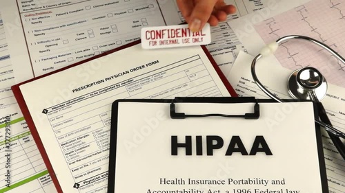 Health Insurance Portability and accountability act HIPAA, red folder with inscription confidential, medication request form and stethoscope on a blue velvet background. Close-up