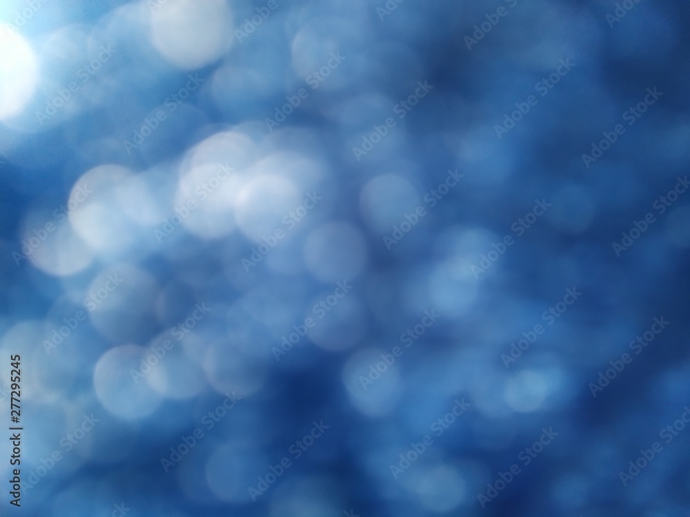 white glitter on dark blue denim background