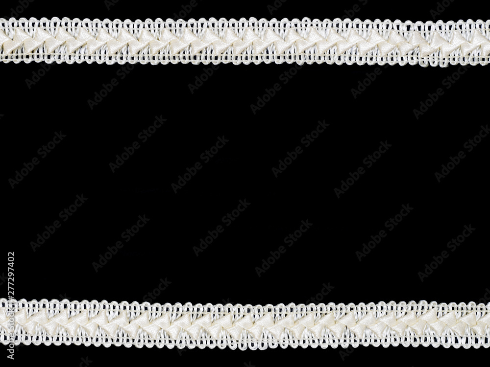 Beige laces on black background Beige laces on black background