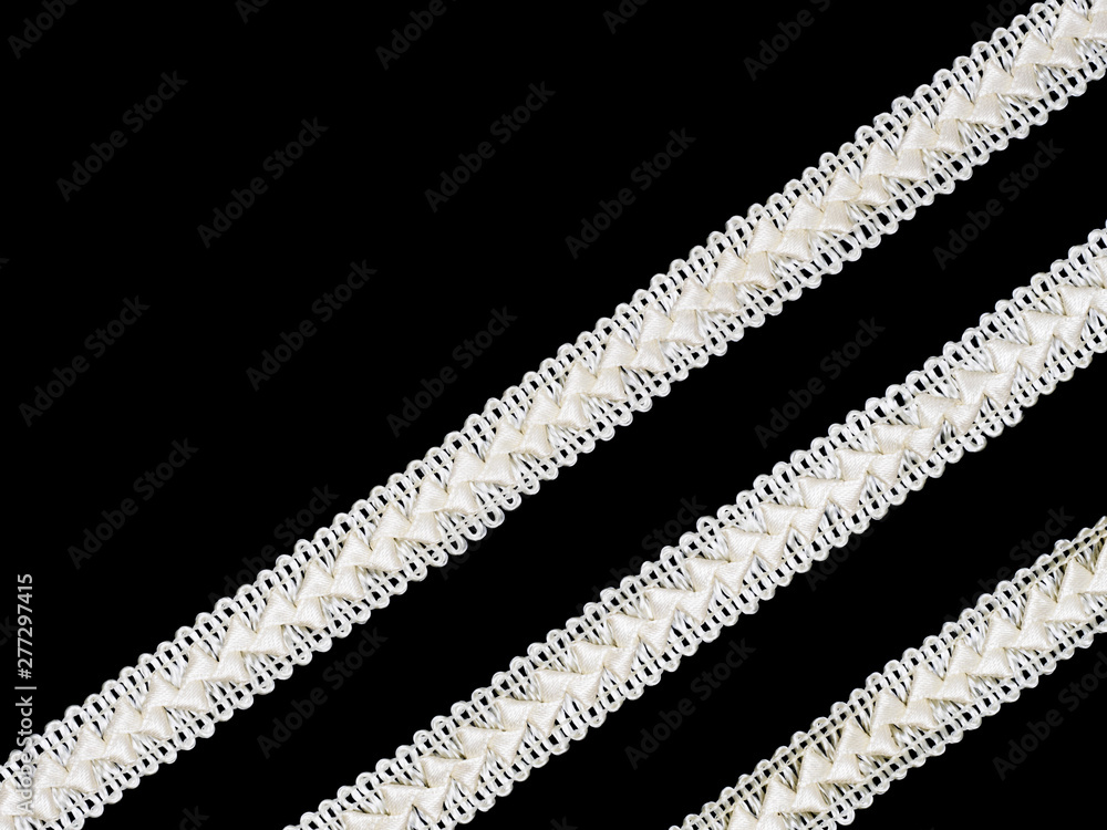 Beige laces on black background