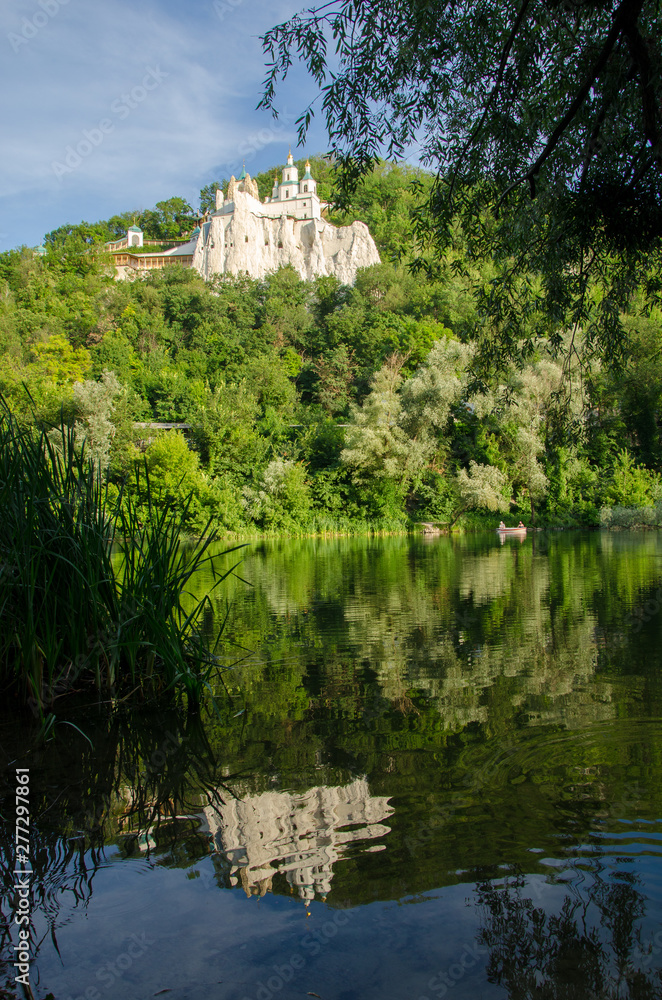 Evening landscape with Svyatogorsk Lavra on the background of the river