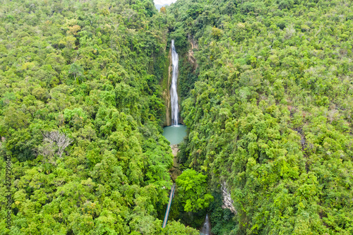 Waterfall in the jungle. Mantayupan Falls, view from above. Mantayupan Falls is one of the highest waterfalls in Cebu. The second level of the waterfalls has 98 meters high. photo