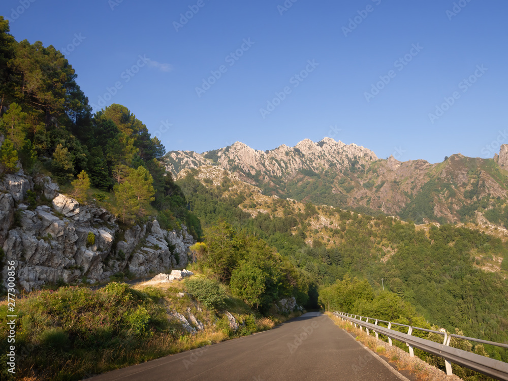 Mountain road in the Apuan Alps, Alpi Apuane, near the Vestito Pass. Above Massa Carrara, Italy. Open road, travel.