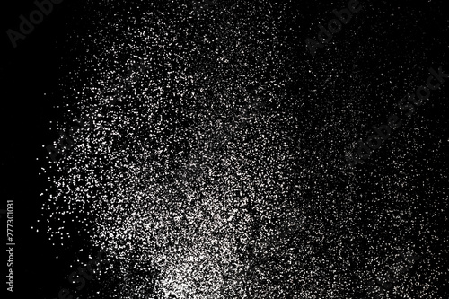 White powder splash isolated on black background. Flour sifting on a black background. Explosive powder white