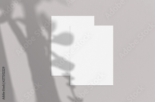 Blank white vertical paper sheet 5x7 inches with shadow overlay. Modern and stylish greeting card or wedding invitation mock up.