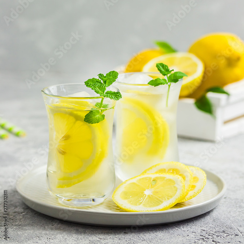 Iced lemon mint tea with ginger and honey. Selective focus, space for text.