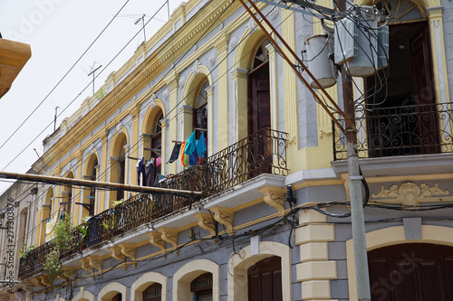 Santiago de Cuba, Cuba - July 12, 2018: Colorful street in Santiago de Cuba. It has long been the second-most important city on the island after Havana, and still remains the second-largest