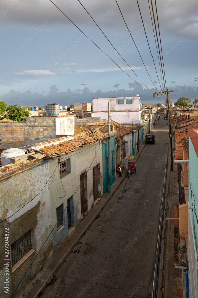 Camaguey, Cuba - July 18, 2018: Old colorful street at sunset in Camaguey in Cuba.