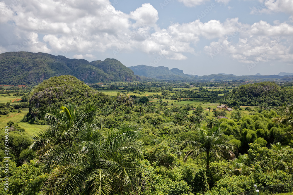 Vinales, Cuba - July 27, 2018: Green caribbean valley with small cuban houses and mogotes hills landscape panorama, Vinales, Pinar Del Rio, Cuba