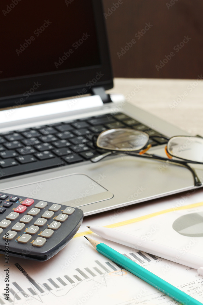 Business concept with a report, money and a calculator Business concept with a report, money and a calculator
