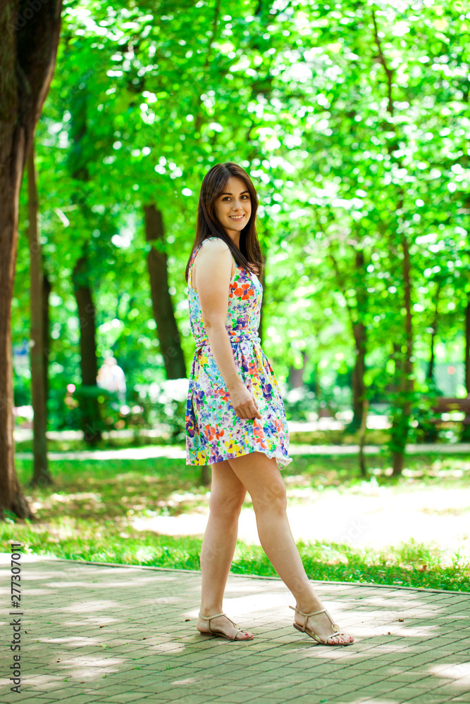 Young beautiful woman in dress in the summer park Young beautiful woman in dress in the summer park
