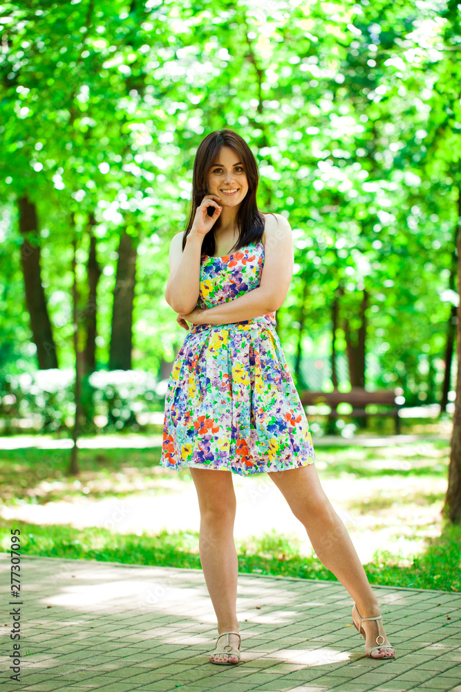 Young beautiful woman in dress in the summer park Young beautiful woman in dress in the summer park