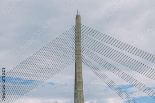 City Riga, Latvia Republic. Urban city cable bridge and river. Old metal constructions. July 4. 2019