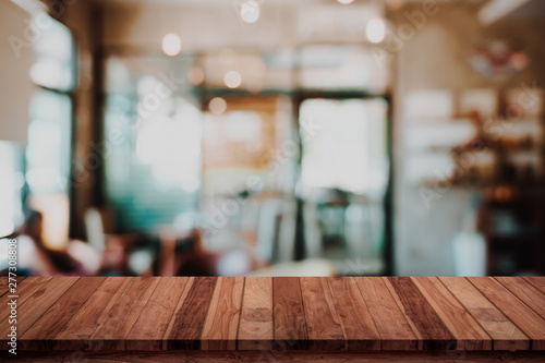 Empty wood table with blur cafe or coffee shop background. photo