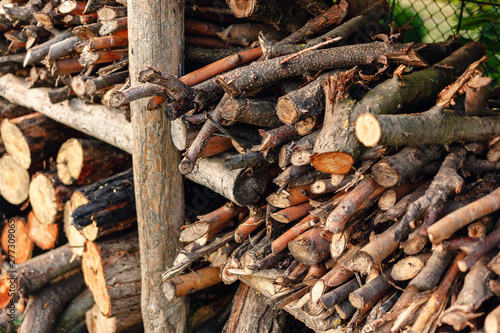 Preparation of firewood for the winter. Firewood background. Stacks of firewood.