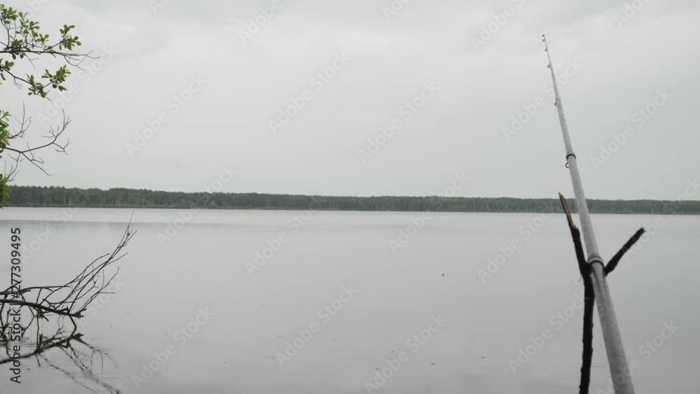 Fishing bobber floating on the surface of the water in rainy day. Fishing bobber floating on the surface of the water in rainy day.