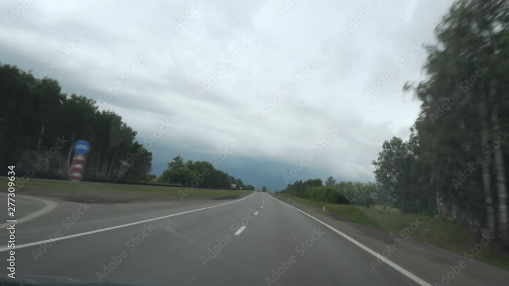View on highway through windshield. Drive in cloudy day. View on highway through windshield. Drive in cloudy day.