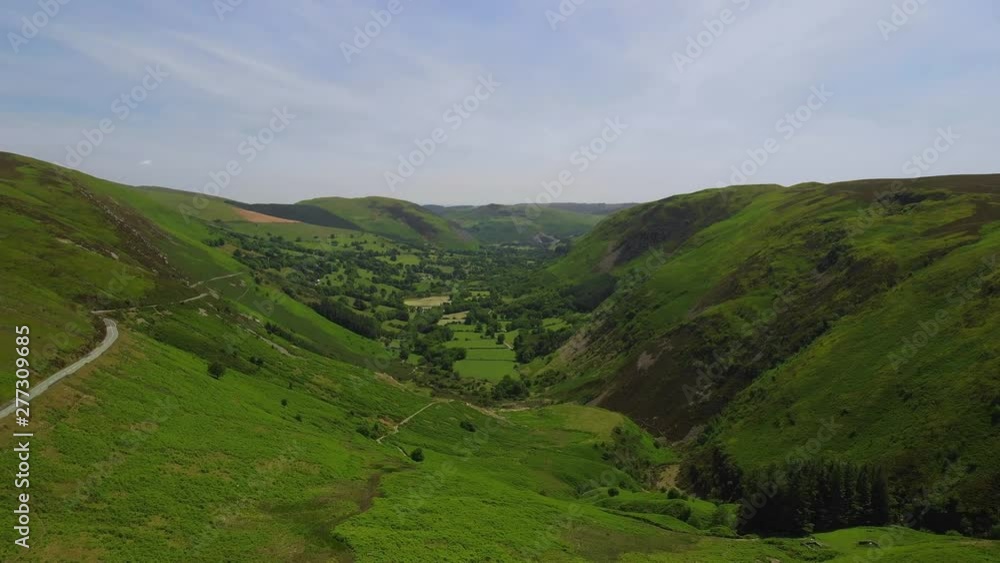 Milltir Cerrig Mountain Pass, through Berwyn range, Powys, Wales - flying alongside B4391 - moorland, isolation - aerial drone looking down valley farmland towards Llangynog - 4K 23.89fps Milltir Cerrig Mountain Pass, through Berwyn range, Powys, Wales - flying alongside B4391 - moorland, isolation - aerial drone looking down valley farmland towards Llangynog - 4K 23.89fps