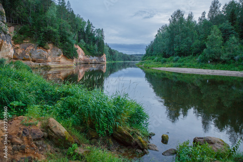 City Cesis  Latvia Republic. Red rocks and river Gauja. Nature  and green trees in summer. July 4. 2019 Travel photo.