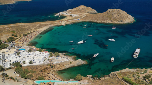 Aerial drone photo of small peninsula with picturesque chapel and beach of Agia Anna as well as small beach of Divounia, island of Mykonos, Cyclades, Greece photo