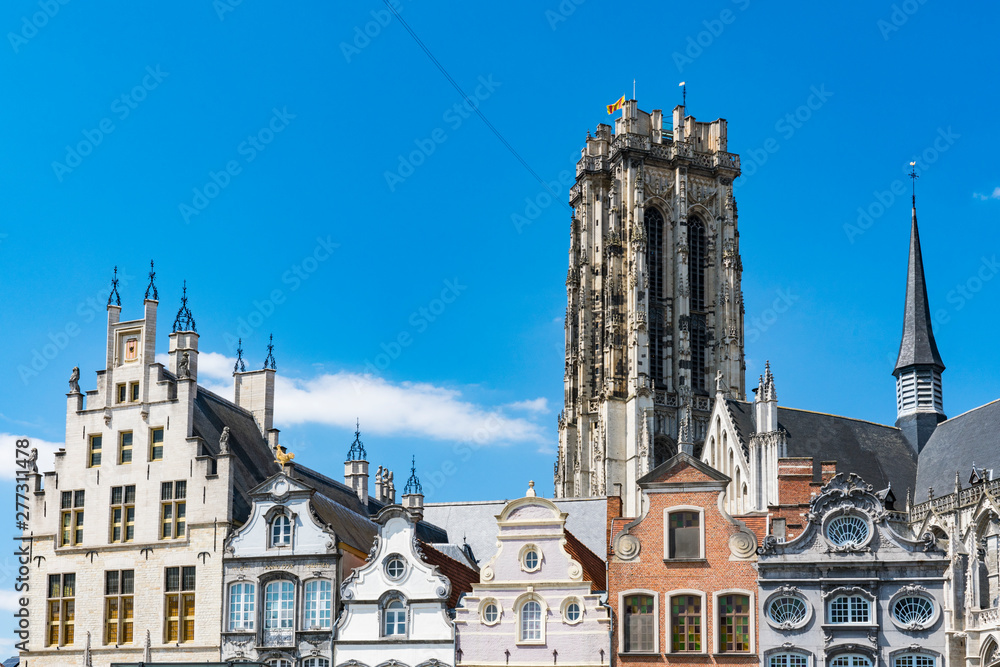 houses on sqaure called Grote Markt and tower of St. Rumbold's Cathedral  in Mechelen, Belgium