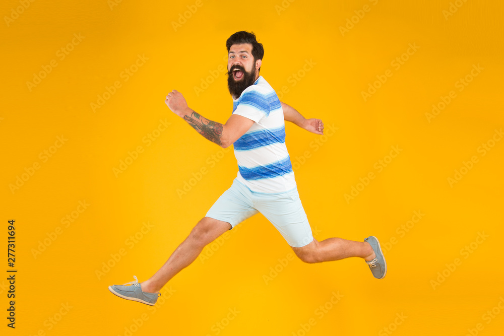 Summer style. Sale and discount. Hurry up. Summer vacation. Man bearded hipster with mustache long beard running yellow background. Guy dressed striped shirt on summer vacation. Barbershop concept