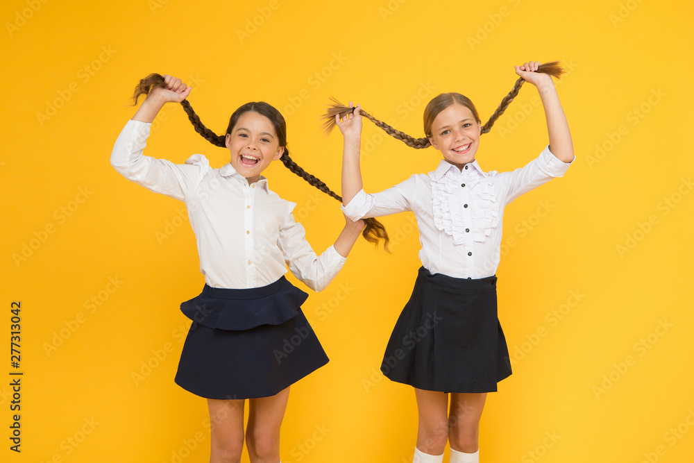 Naklejka premium Schoolgirls formal style perfect school uniform. Happy childhood. School moments. Kids cute students. Education is not only about knowledge. Classmates having fun at school Friends adorable pupils